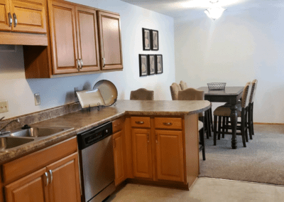 A well-equipped kitchen displaying a sink, stove, and refrigerator, emphasizing practicality and style.